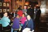Seated: member Tony (BS), non member niece of Val, members Val and Nigel (SOS). In background: other members.