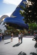 Standing by the sorcerer's hat that Mickey took for a joyride in Fantasia.