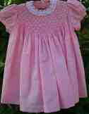 Smocked and richly beaded baby dress