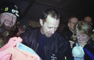 Visiting trike rider wonders which dvd to watch when he returns to the mansion(tent)