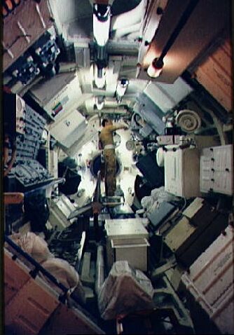 March 1, 1973 - Astronaut Charles Conrad Jr., 
      commander of the first manned Skylab mission, goes through a checklist of experiment activity during Skylab training at JSC. Conrad is standing in the Multiple Docking Adapter (MDA) in the Mission Simulation and Training Facility At JSC. He is working at the materials