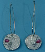 PMC lets you press set man made gems, forming thier own bezel as they dry and kiln.
