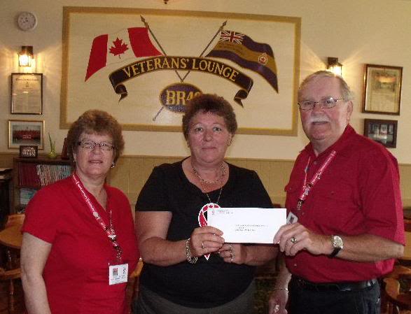 Donna of the Morrisburg Legion accepts cheque for the Legion Poppy Fund from RED Ribbon Force