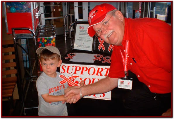 Little Cameron shows support with Red Ribbon for his dad and fellow troops