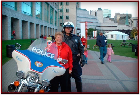 Sgt. Mark Benson dislpays red ribbon on two wheels