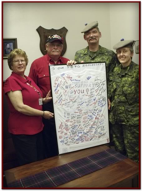 LCol R. C Duda and Capt. Harrison of the Cornwall S D and G Highlanders receiving a token of support in the form of a signed T-Shirt from many Cornwall area proud Canadians!!