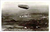 Postcard showing the GRAF ZEPPELIN in flight over Friederichshafen, Germany,
with the zeppelin works in the background.

Click to see an actual-size picture.