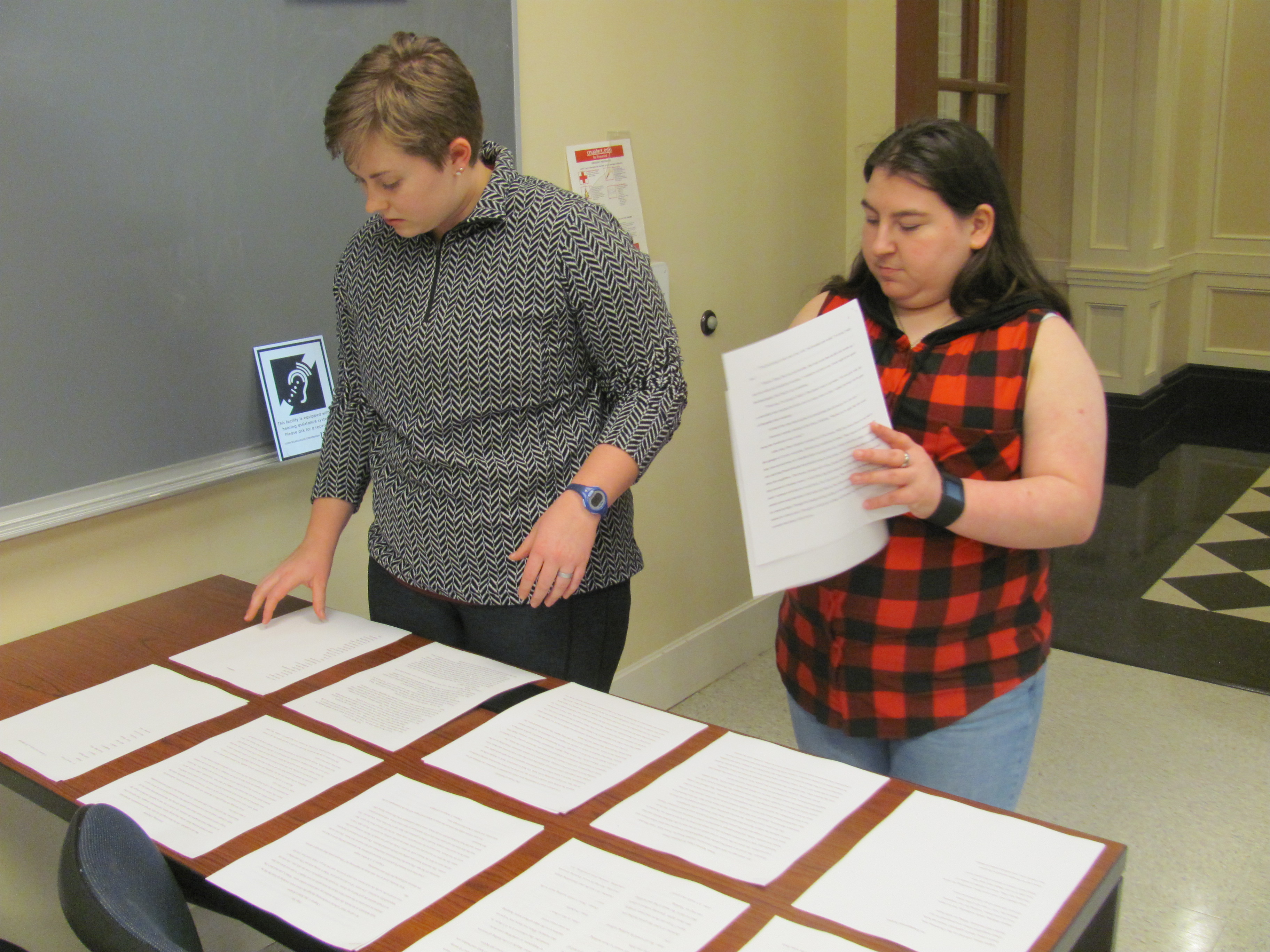 Maddie (left) and Kayleigh (right) look over the submissions for Currents.
