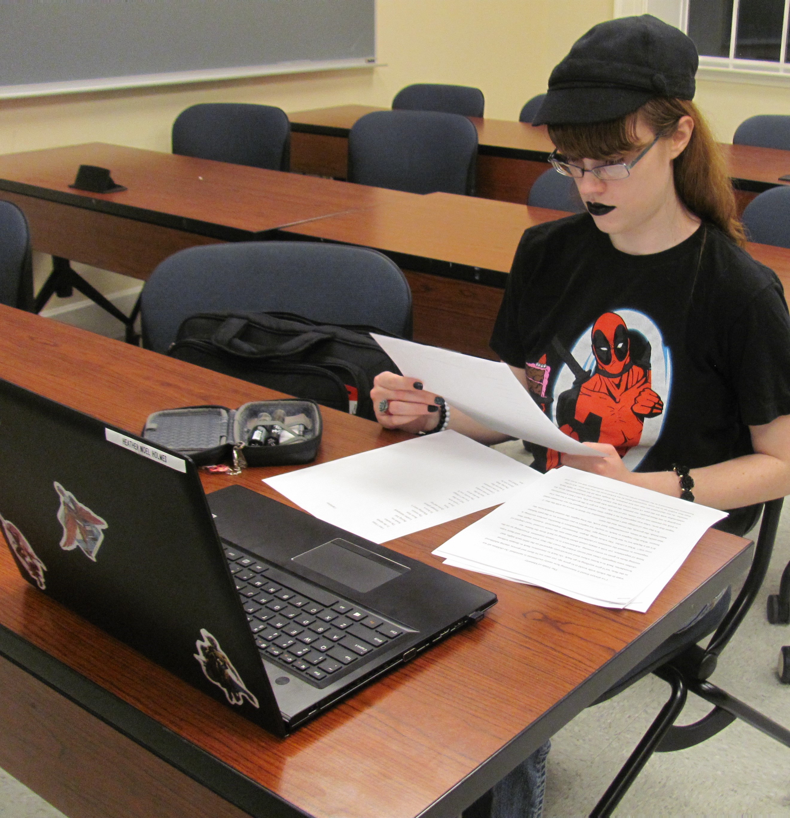 Heather reading over printed works.