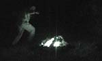 Night vision view of Ritchie dancing around the fire