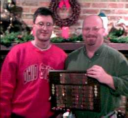 Past Club Champion Vince passes the plaque to Tom