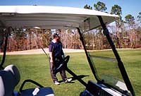 John watches the flight of a laser-accurate 8 iron
