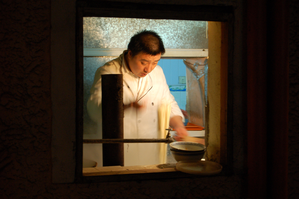 An image of our chef preparing food in our gourmet kitchen.