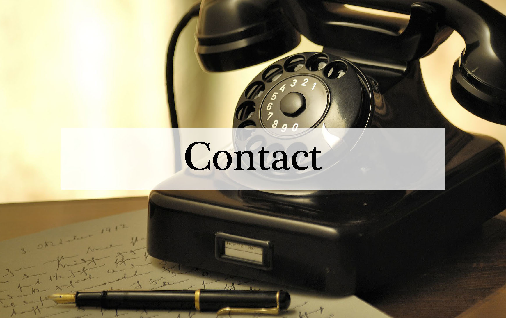 old telephone and paper sitting on a table with the word contact