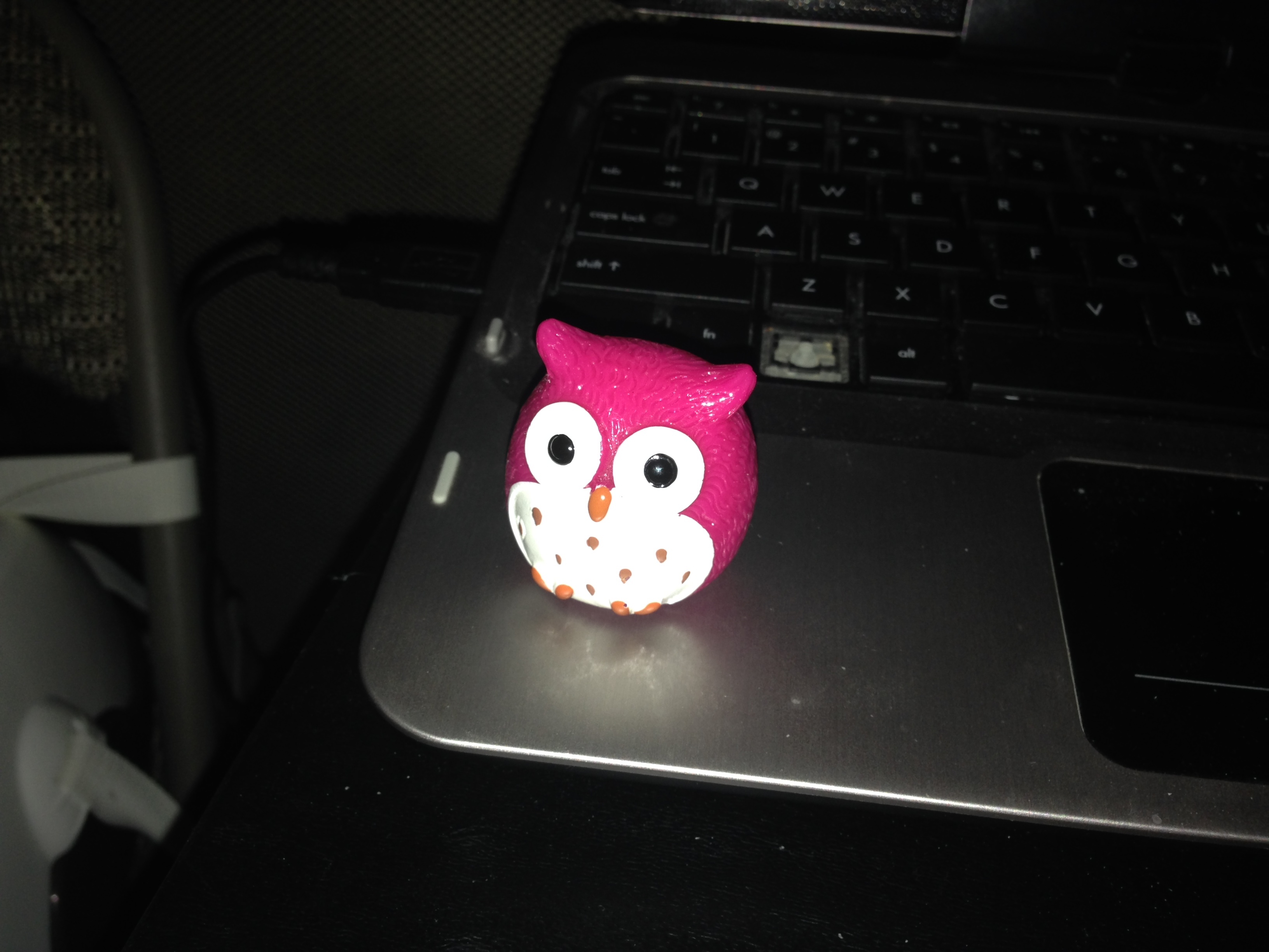 Little pink owl lip balm sitting on my laptop.