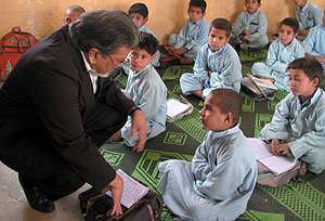 Arshad Husain, MD, talks with Afghan boys at a refugee school in Pakistan.