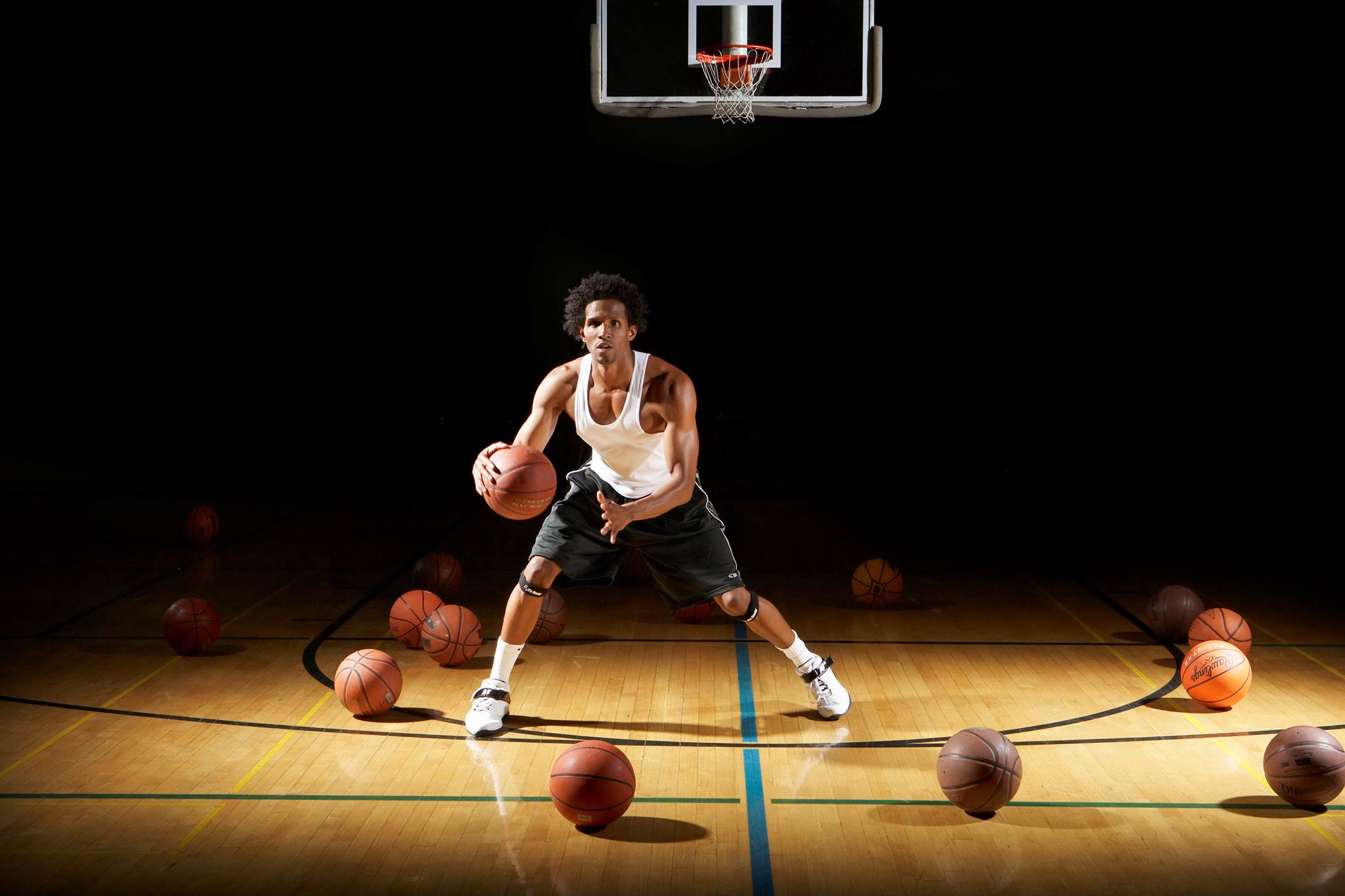 Basketball player dribbling ball on court
