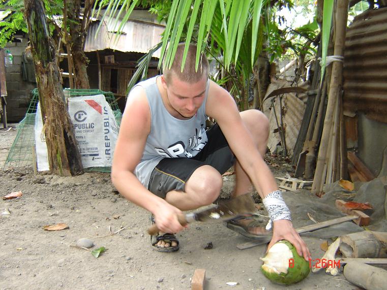 Damian openning a coconut
