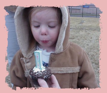 Maria Blowing Out Abigail's First Birthday Cupcake