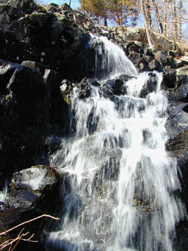 A small waterfall over a rock ledge