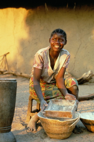 Girl sifting pounded yam