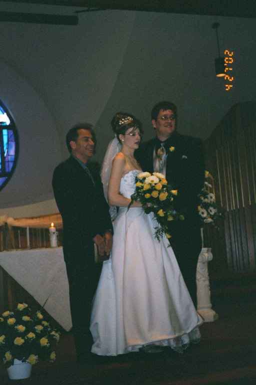 The happy couple with Pastor Bill Lighty