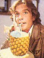 Murphy Wegg in his office at the National Broadcasting Association. In the 5th script draft, he is 'drinking a fancy drink out of a pineapple', so this picture could be from a section that was cut from the final edit.