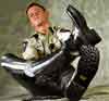 Leather breeches and textile shirt  pulling on motor  cop boots