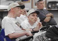Sidney Bradley (left) listens to a deer hunting seminar at 'A Day at the Range' event for those outdoors enthusiasts with disabilities.